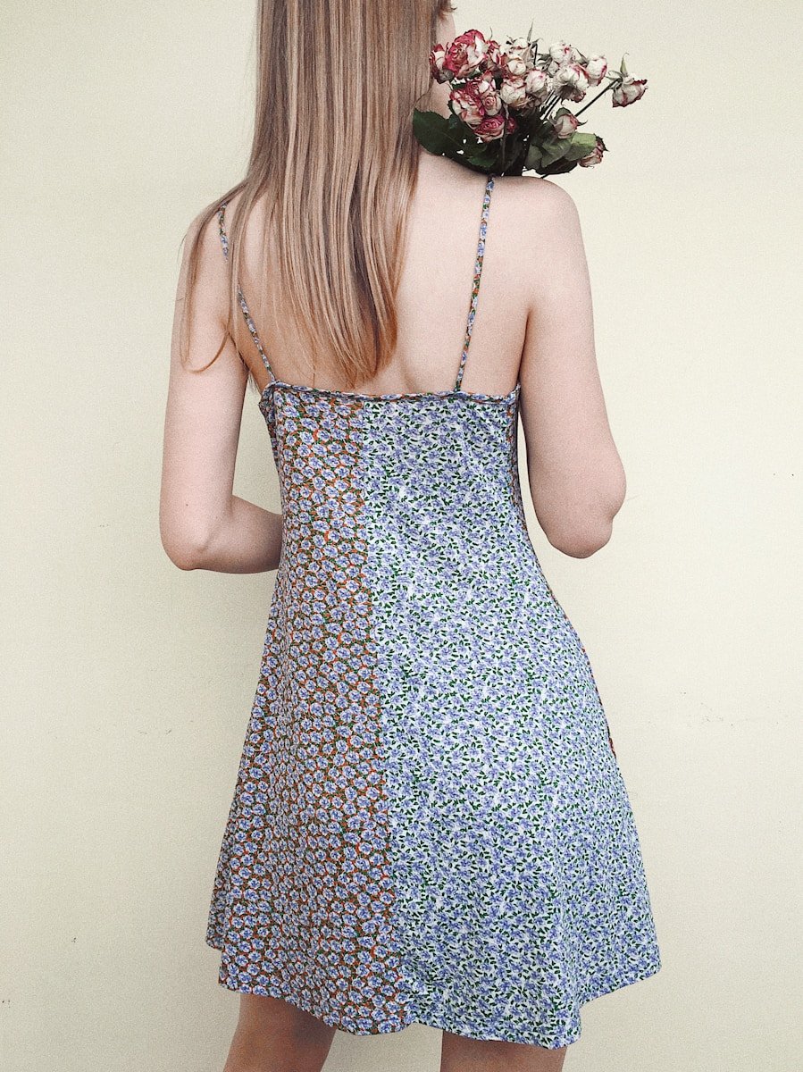 woman in blue and white floral spaghetti strap dress